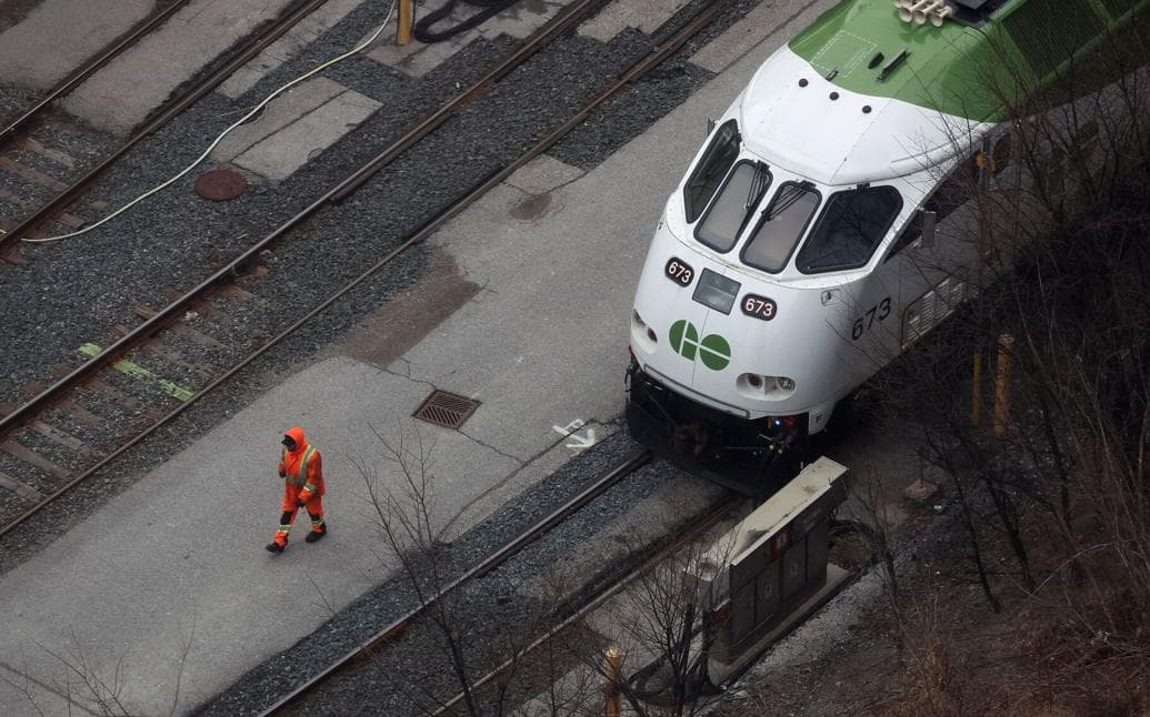 GO train on railway tracks — aerial view showing aging infrastructure